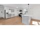 Modern kitchen with stainless steel appliances, light wood floors, and a center island with sink at 1254 Mcdougal St, Indianapolis, IN 46203