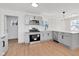 Modern kitchen with stainless steel appliances, white countertops, and light wood floors at 1254 Mcdougal St, Indianapolis, IN 46203
