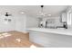Open-concept kitchen featuring stainless steel appliances, wood floors, and modern lighting fixtures at 1254 Mcdougal St, Indianapolis, IN 46203