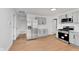 Modern kitchen with stainless steel appliances, gray cabinetry, and light wood-style flooring at 1254 Mcdougal St, Indianapolis, IN 46203