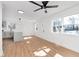 Inviting living room with light wood floors, a ceiling fan, and an open layout leading to the kitchen at 1254 Mcdougal St, Indianapolis, IN 46203