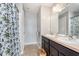 Bathroom with double sinks, tiled floor, and a shower with a leafy shower curtain at 12777 Rotterdam Rd, Fishers, IN 46037