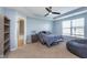 Bedroom with tray ceiling and fan, large window, and ensuite bathroom at 12777 Rotterdam Rd, Fishers, IN 46037