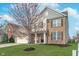 Two-story home with brick accents, a well-manicured lawn, and a charming tree in the front yard at 12777 Rotterdam Rd, Fishers, IN 46037