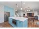 Open-concept kitchen with an island, modern appliances, and seamless flow to the dining area at 12777 Rotterdam Rd, Fishers, IN 46037