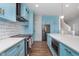 Modern kitchen featuring stainless appliances, subway tile, blue cabinets, and a large island at 12777 Rotterdam Rd, Fishers, IN 46037