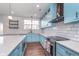Updated kitchen with subway tile, white countertops, stainless appliances, and blue cabinets at 12777 Rotterdam Rd, Fishers, IN 46037