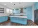 Bright kitchen with stainless appliances, white subway tile, blue cabinets, and a large island at 12777 Rotterdam Rd, Fishers, IN 46037