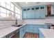 Bright kitchen with white countertops, stainless appliances, subway tile, and blue cabinets at 12777 Rotterdam Rd, Fishers, IN 46037