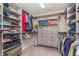 Well-organized walk-in closet with built-in shelving, drawers, and ample storage space for clothing at 12777 Rotterdam Rd, Fishers, IN 46037
