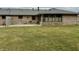 Backyard with a well maintained lawn, windows, and patio at 1408 Lawrence Way, Anderson, IN 46013