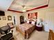 This bedroom offers a ceiling fan, sitting area and a bed with a decorative spread and a closet door at 1408 Lawrence Way, Anderson, IN 46013
