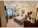 This bedroom features a tray ceiling with fan, decorative artwork, and traditional furnishings at 1408 Lawrence Way, Anderson, IN 46013