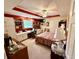 This bedroom features red accents, a ceiling fan, built-in shelving and desk area and a queen size bed at 1408 Lawrence Way, Anderson, IN 46013