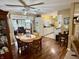 Dining area with wood floors, a view of the living area, and an open layout to the kitchen at 1408 Lawrence Way, Anderson, IN 46013