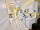 Galley kitchen features white cabinetry, tile flooring and white appliances at 1408 Lawrence Way, Anderson, IN 46013