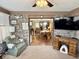 Inviting living space with brick accent wall, desk and cozy seating and dining area view at 1408 Lawrence Way, Anderson, IN 46013