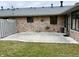 Back of the house featuring a cement patio, grass, and brick exterior walls at 1408 Lawrence Way, Anderson, IN 46013
