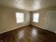 Bright living room with hardwood floors and natural light from two windows at 1422 E 49Th St, Indianapolis, IN 46205