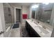 Modern bathroom featuring a double vanity with quartz countertops and a glass-enclosed shower at 15408 Brown Jack Dr, Fishers, IN 46040