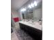 Bright bathroom with double vanity, quartz countertop, and a view of the glass-enclosed shower at 15408 Brown Jack Dr, Fishers, IN 46040