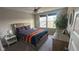 Cozy bedroom featuring a bed with a patterned comforter, a ceiling fan, and natural light from a window at 15408 Brown Jack Dr, Fishers, IN 46040