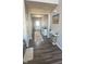 Inviting entryway with hardwood floors, white wainscoting, console tables, and a colorful patterned rug at 15408 Brown Jack Dr, Fishers, IN 46040
