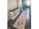 Inviting entryway with hardwood floors, decorative cabinet and console table, and a colorful patterned rug at 15408 Brown Jack Dr, Fishers, IN 46040