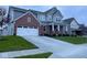 Beautiful two-story home featuring a brick facade, attached two-car garage, concrete driveway, and a well-maintained lawn at 15408 Brown Jack Dr, Fishers, IN 46040