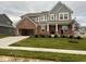Two-story home with a brick facade, attached two-car garage, concrete driveway, and a well-maintained lawn at 15408 Brown Jack Dr, Fishers, IN 46040