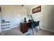 Home office featuring neutral walls, carpet flooring, a dark wood desk, two chairs, and decorative shelving at 15408 Brown Jack Dr, Fishers, IN 46040