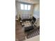 Spacious living room with soaring ceilings, hardwood floors, large windows, fireplace, and comfortable seating at 15408 Brown Jack Dr, Fishers, IN 46040