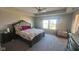 Spacious main bedroom featuring a tray ceiling, carpet and natural light from the large window at 15408 Brown Jack Dr, Fishers, IN 46040
