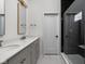 Bathroom featuring a double vanity with grey cabinets, quartz countertop and a glass shower at 1668 Carrollton Rail Dr, Westfield, IN 46074
