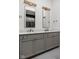 Bathroom with a double sink vanity, grey cabinets and bronze fixtures at 1668 Carrollton Rail Dr, Westfield, IN 46074
