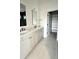Elegant bathroom featuring double vanity with stone countertop and a separate closet at 1668 Carrollton Rail Dr, Westfield, IN 46074