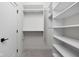Well-organized walk-in closet featuring white shelving and ample storage space at 1668 Carrollton Rail Dr, Westfield, IN 46074