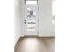 Bright entryway featuring hardwood floors and a modern white door with black hardware at 1668 Carrollton Rail Dr, Westfield, IN 46074