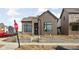 New construction home showing exterior brick and vertical wood paneling with professional landscaping underway at 1668 Carrollton Rail Dr, Westfield, IN 46074