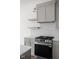 Modern kitchen featuring stainless steel appliances, gray cabinets, and quartz countertops at 1668 Carrollton Rail Dr, Westfield, IN 46074
