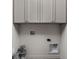 Convenient laundry area with overhead cabinets and plumbing connections for washer and dryer at 1668 Carrollton Rail Dr, Westfield, IN 46074