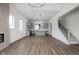 Open living space connecting to a modern kitchen with a large island and a staircase at 1668 Carrollton Rail Dr, Westfield, IN 46074