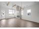Spacious living room with vaulted ceilings, wooden beams, fireplace, and ample natural light at 1668 Carrollton Rail Dr, Westfield, IN 46074