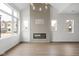 Bright living room with a modern fireplace, wood accent wall, and light hardwood floors at 1668 Carrollton Rail Dr, Westfield, IN 46074