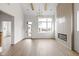Open-concept living room featuring a fireplace, hardwood floors, and natural light at 1668 Carrollton Rail Dr, Westfield, IN 46074