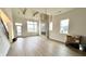Bright living room featuring modern lighting fixture, fireplace, and an abundance of natural light at 1668 Carrollton Rail Dr, Westfield, IN 46074