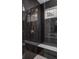 Elegant walk-in shower with dark tiling, a built-in bench and a bronze shower fixture at 1668 Carrollton Rail Dr, Westfield, IN 46074