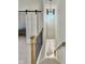 Staircase featuring modern chandelier, wood railing, and access to another room with a barn door at 1668 Carrollton Rail Dr, Westfield, IN 46074