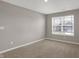Bedroom with carpet, a window bringing in natural light, and painted in a modern light grey color scheme at 1704 Beach St, Greenwood, IN 46143