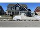 Charming two-story home featuring a two-car garage and a well-maintained front lawn on a clear winter day at 1704 Beach St, Greenwood, IN 46143